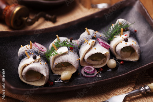 Rolled herring in vinegar, served with onions and pickles.