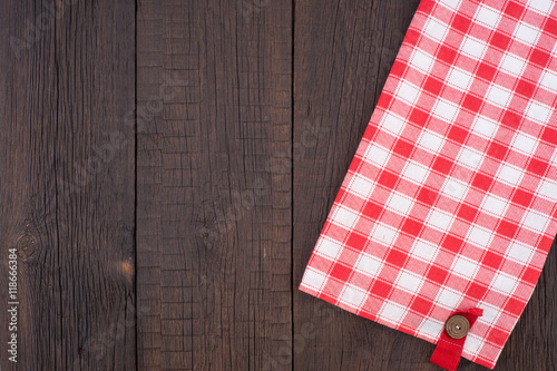 Rustic wooden boards with a red checkered tablecloth.