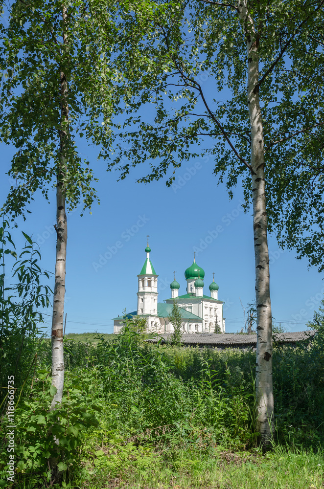 Old Russian Church on a background of birch trees