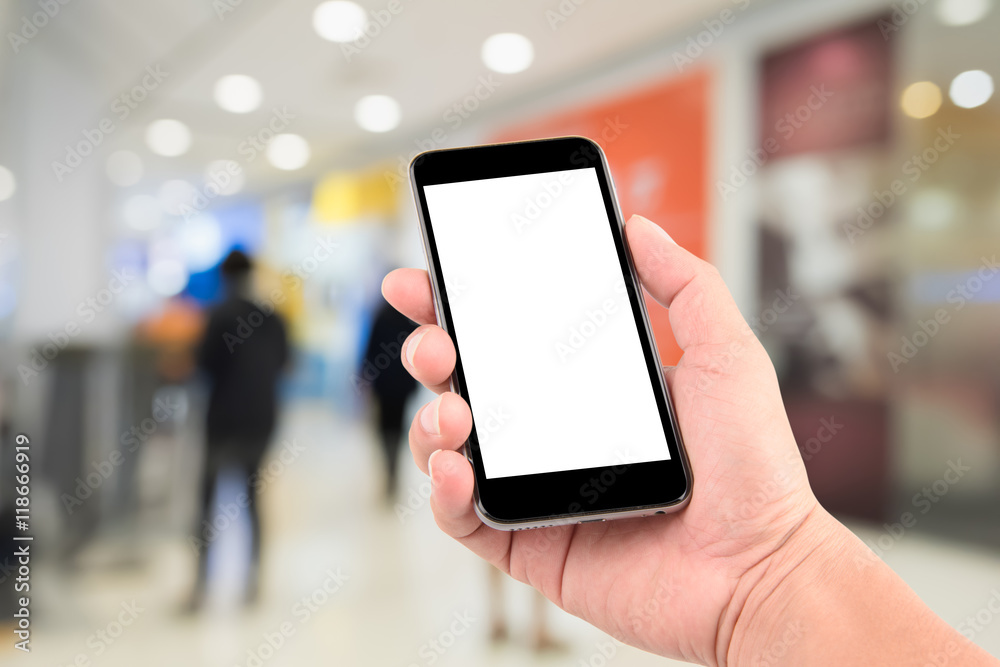Smart phone with white screen in hand on blurred in shopping mal Smart phone with white screen in hand on blurred in shopping mal