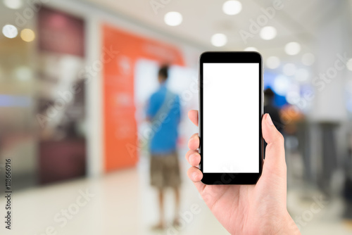 Smart phone with white screen in hand on blurred in shopping mal