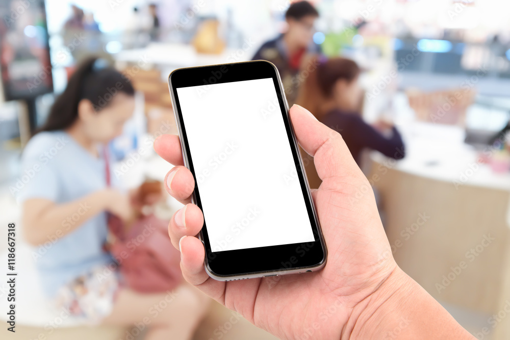 hand holding the phone tablet on blurred in shop counter service background;Transactions by smartphone concept hand holding the phone tablet on blurred in shop counter service background;Transactions by smartphone concept