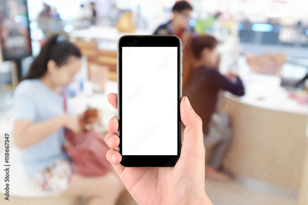 hand holding the phone tablet on blurred in shop counter service background;Transactions by smartphone concept