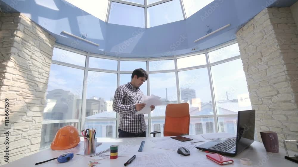 Tired, exhausted, businessman throwing a pile of documents in a clean bright office. HD. Tired, exhausted, businessman throwing a pile of documents in a clean bright office. HD.