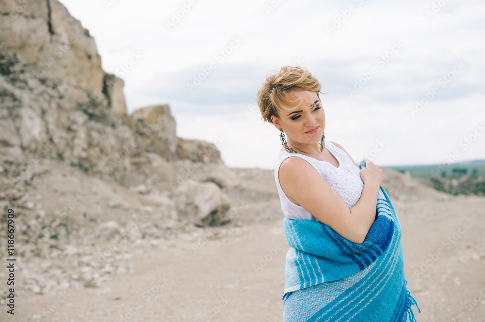 Pregnant woman and man photo shoot in a stone quarry