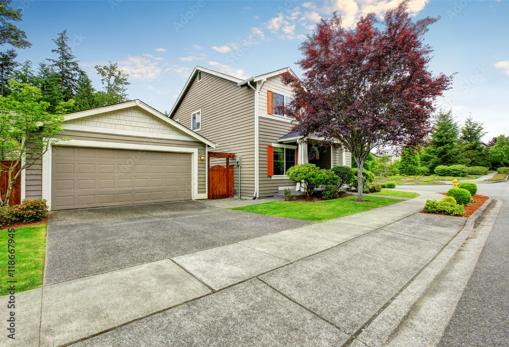 House exterior with siding trim, garage and concrete walkway House exterior with siding trim, garage and concrete walkway