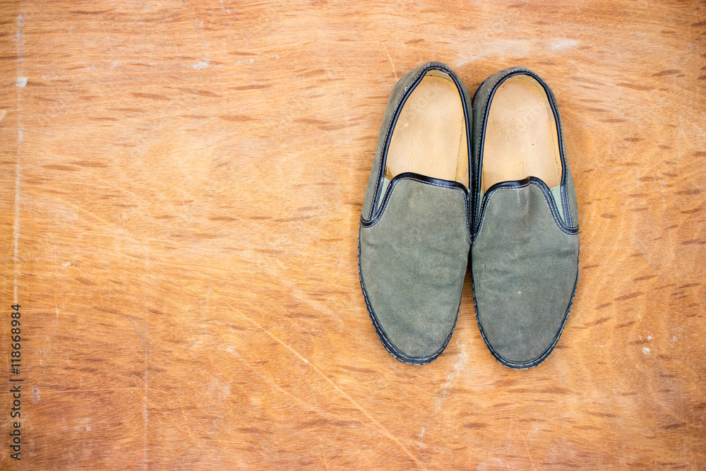 Green old shoes on wooden floor Green old shoes on wooden floor