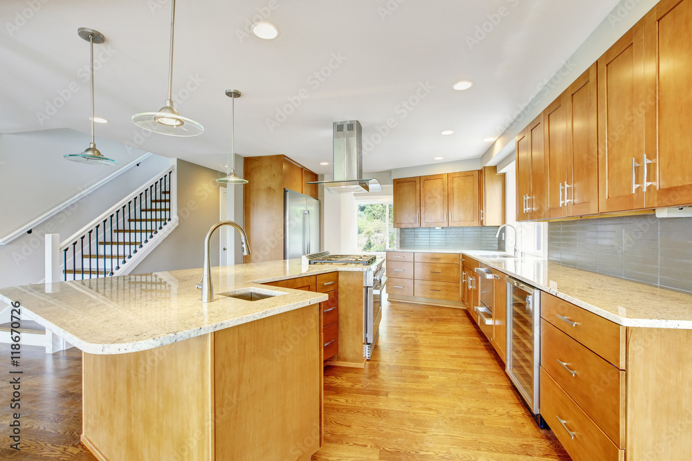 Kitchen room with wooden cabinets, granite counter top and island. Kitchen room with wooden cabinets, granite counter top and island.