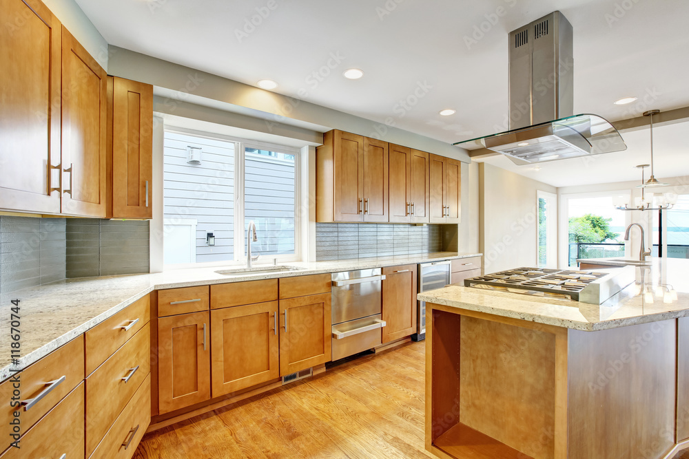 Fototapeta premium Kitchen room with wooden cabinets, granite counter top and island.