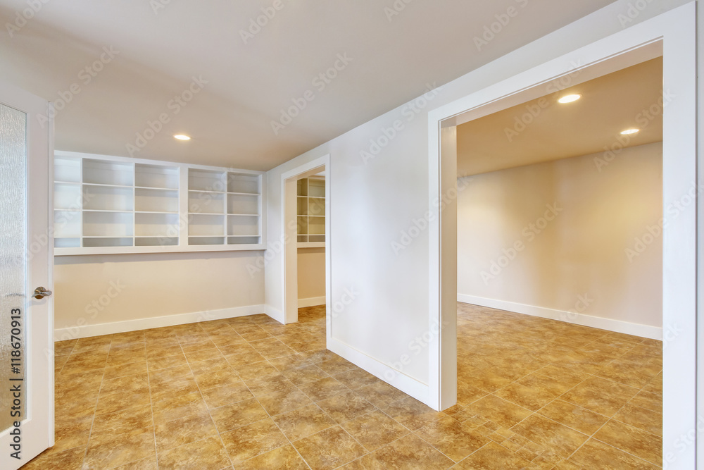 Open floor plan interior with light tones walls and tile floor. Open floor plan interior with light tones walls and tile floor.