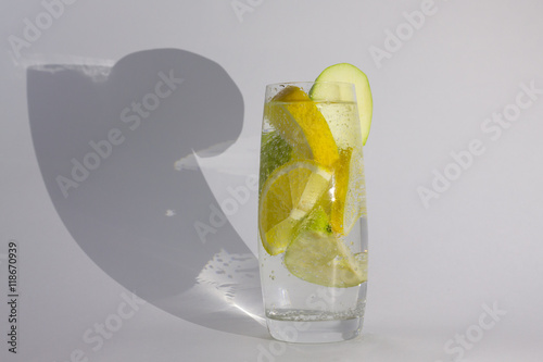 apples and lemon in a glass with shadow