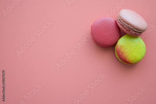 Colorful france macarons on pink background.