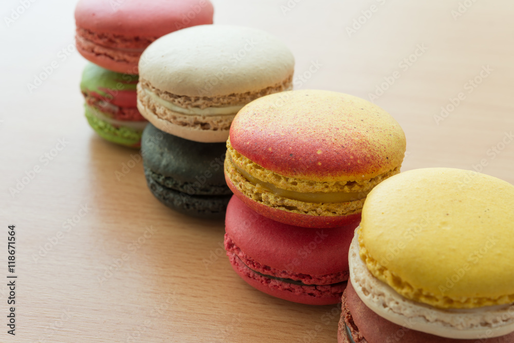Colorful france macarons on wooden background.
