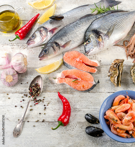 Photography Fresh fish and other seafood on wooden background.