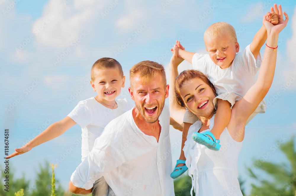 Happy young family with two children having fun together Happy young family with two children having fun together
