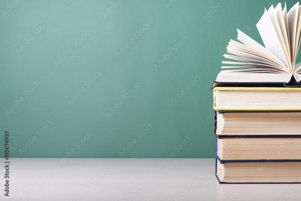 Naklejka premium Open book, hardback books on wooden table. Education background. Back to school. Copy space for text.