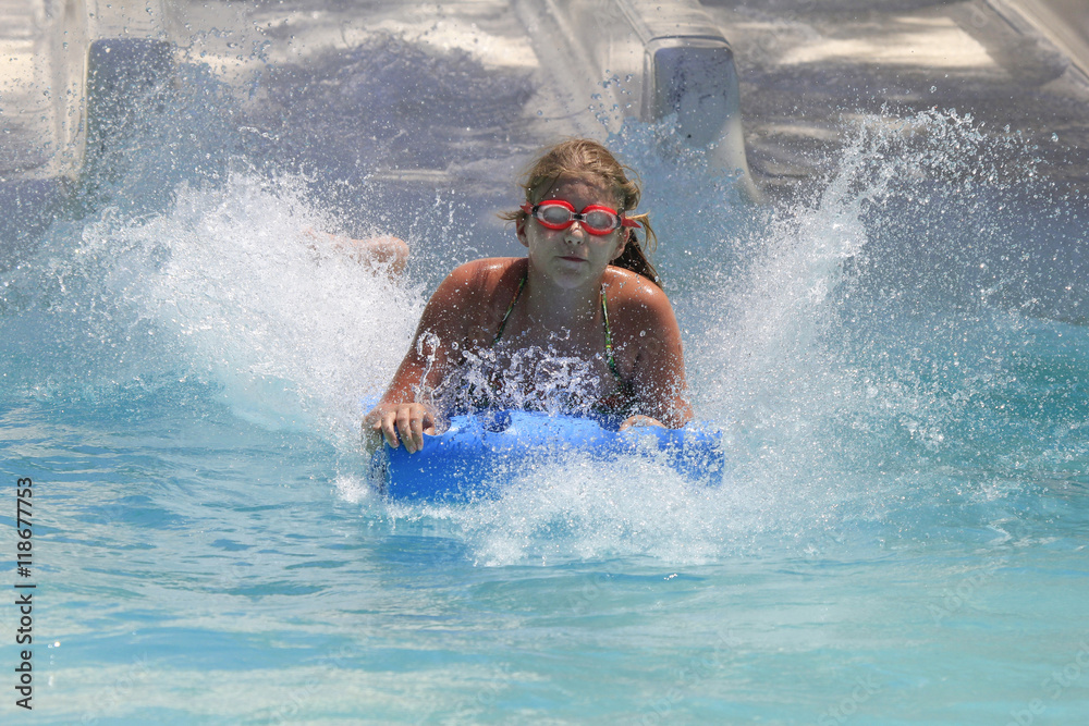 The cute little girl joying  in the water park