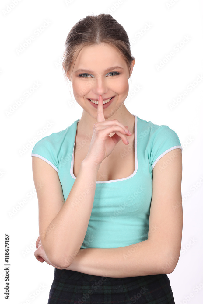 Smiling lady with finger on her lips. Close up. White background Smiling lady with finger on her lips. Close up. White background