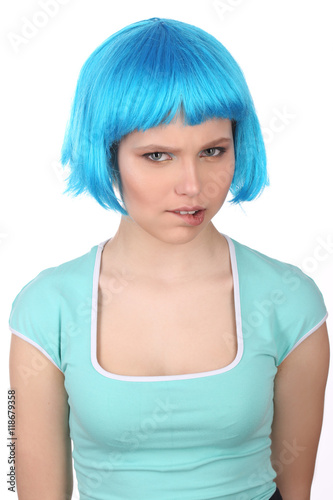 Girl in blue wig bitting her lip. Close up. White background