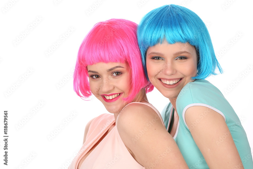 Smiling teens in colorful wigs posing. Close up. White background Smiling teens in colorful wigs posing. Close up. White background