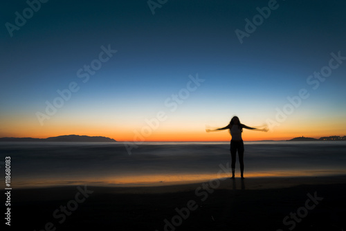 Woman silhouette on the beach