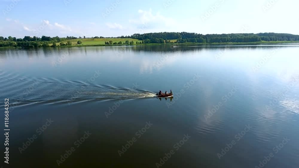 aerial view of travel boat in river with green banks aerial view of travel boat in river with green banks