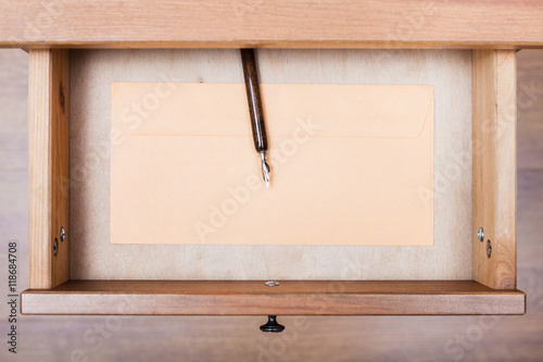 nib pen, paper envelope in open drawer