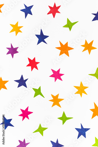 various stars cut out from colored paper on white