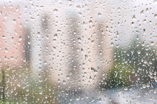 iew of rain drops on window pane of urban house