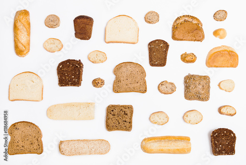 various sliced bread loaves and rolls on white photo