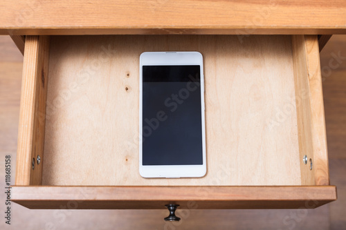 Photo mobile phone in open drawer
