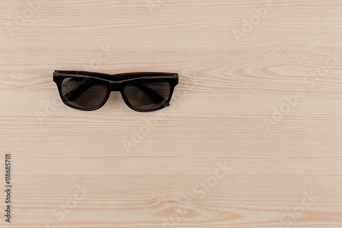 Black vintage sun glasses on wood