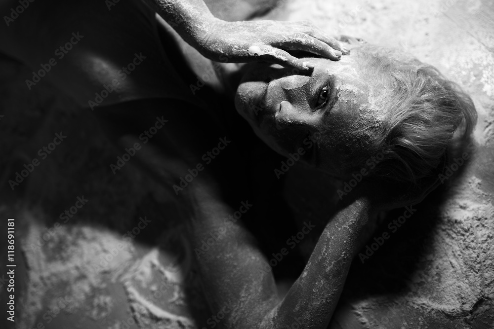 Portrait of beautiful woman lying on the floor with flour