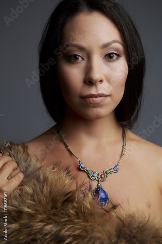 Portrait of a beautiful woman in traditional dress drilled