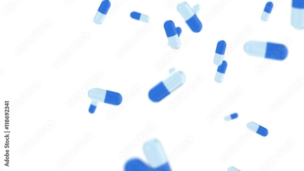 Pills falling on white background in slow motion