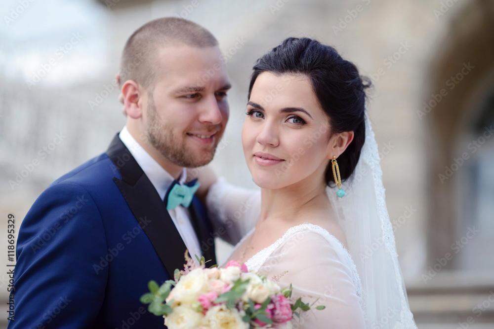Wedding couple on the nature is hugging each other. Beautiful model girl in white dress. Man in suit. Beauty bride with groom. Female and male portrait. Woman with lace veil. Lady and guy outdoors Wedding couple on the nature is hugging each other. Beautiful model girl in white dress. Man in suit. Beauty bride with groom. Female and male portrait. Woman with lace veil. Lady and guy outdoors