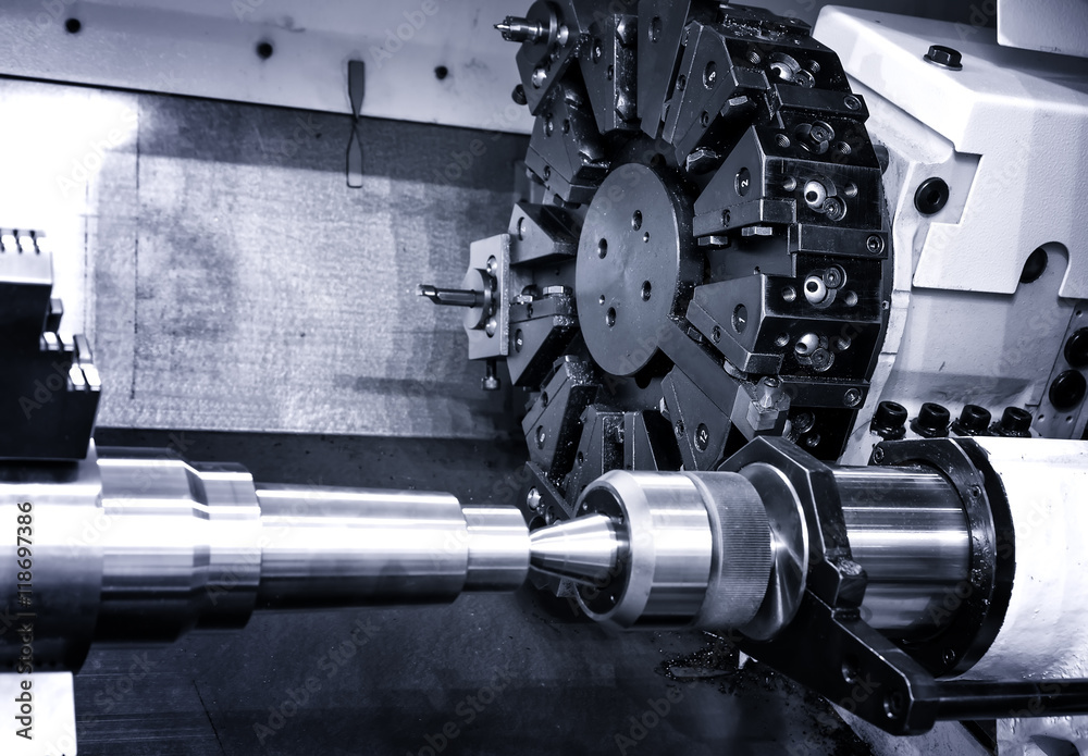 Rotating head with drilling machine bits and tools in a high precision mechanics plant at CNC lathe in workshop Rotating head with drilling machine bits and tools in a high precision mechanics plant at CNC lathe in workshop