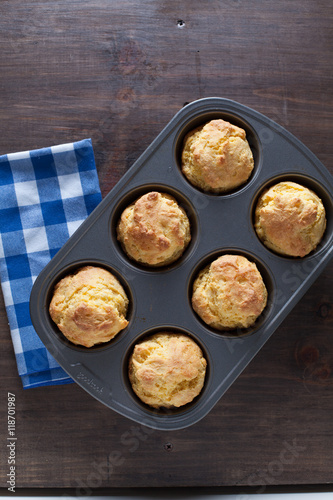 Corn Bread Muffins In Muffin Pan On Country Distressed Wood Tabl