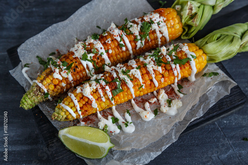 Elote or Mexican grilled corn on the cob served with cotija cheese and chili powder.