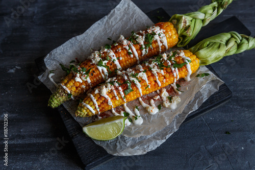 mexican grilled corn, elote, dark photo