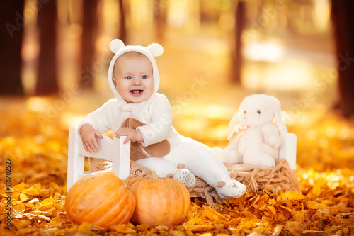 Little boy in autumn orange leaves. Outdoor.