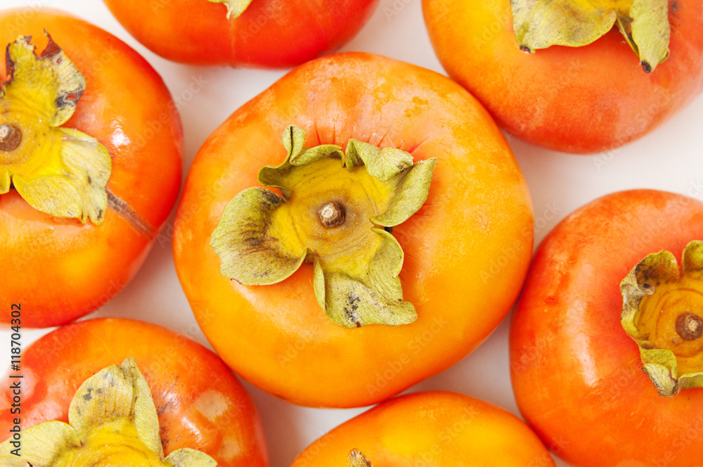 Fototapeta premium persimmons on a white table