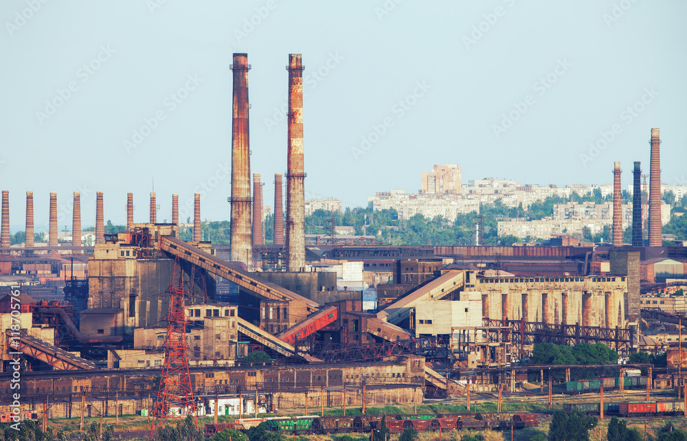 Industrial landscape. Steel factory with pipes at sunset. Metallurgical plant. steelworks, iron works. Heavy industry in Mariupol. Air pollution from smokestacks, ecology problems. Vintage style
