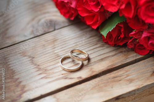 Wedding rings and red roses