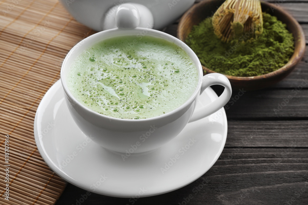 Cup of fresh matcha tea on wooden background Cup of fresh matcha tea on wooden background