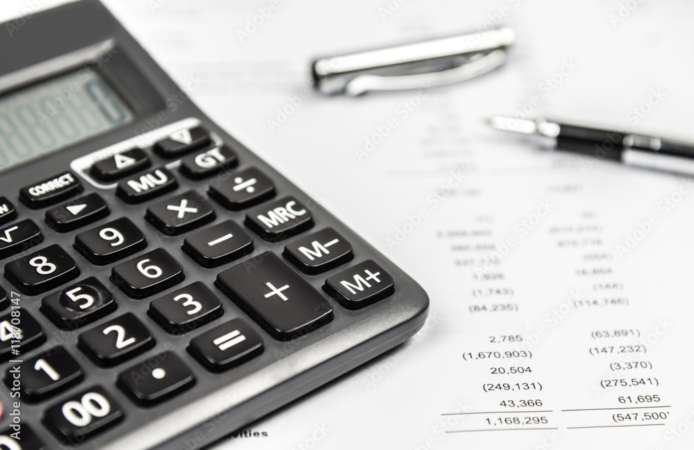 Calculator and pen on financial statement paper. Business accounting concept. Calculator and pen on financial statement paper. Business accounting concept.