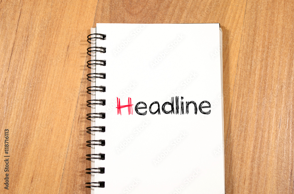 Headline text concept on notebook Headline text concept on notebook
