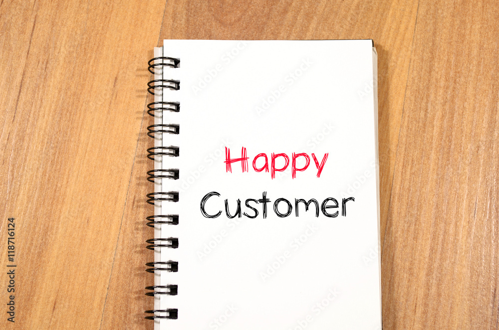 Happy customer text concept on notebook Happy customer text concept on notebook