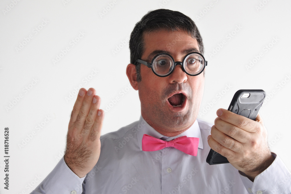 Surprised Geeky man receives a surprising message or phone call Surprised Geeky man receives a surprising message or phone call