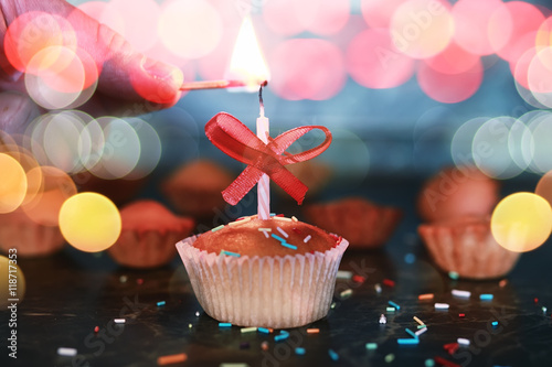 birthday cupcake with a candle bokeh